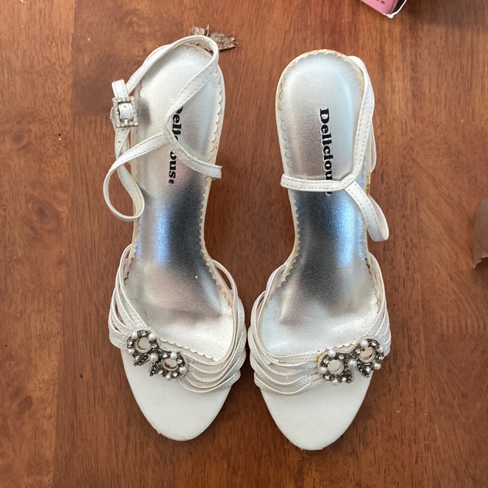 Has beads and gems. White. Good shape.